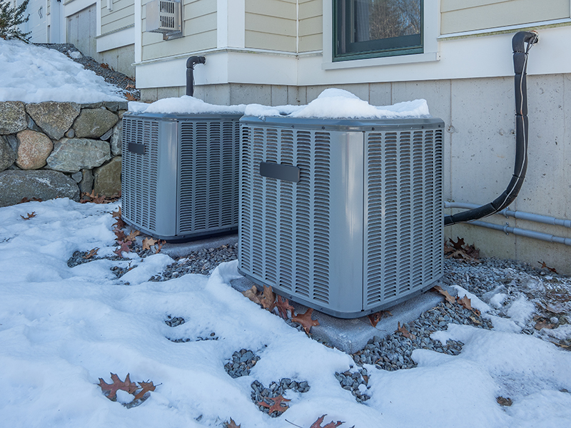 Heat and AC units with snow around them.