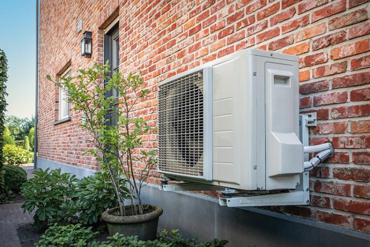 Outdoor heat pump on the facade of home.
